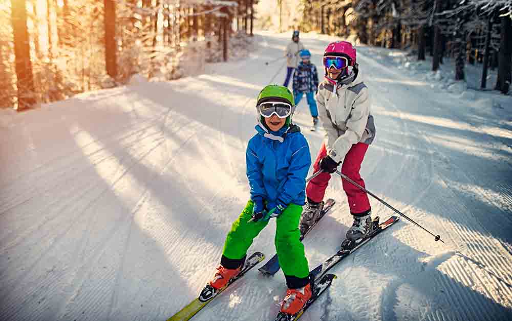 children skiing sun